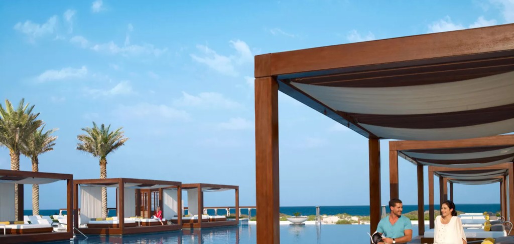 Infinity pool and cabanas at Saadiyat Beach Club on Saadiyat Island near Sei Saadiyat by Aldar, Abu Dhabi — reference lifestyle imagery, not a Sei Saadiyat project render